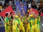 Australia's Matthew Wade celebrates with the trophy and teammates after winning the ICC Men's T20 World Cup