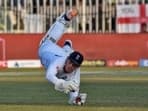 England's wicketkeeper Ollie Pope dives to take a catch