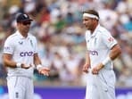 England's James Anderson reacts with Stuart Broad