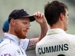 England's Ben Stokes with Australia's Pat Cummins after Australia win the first Test 
